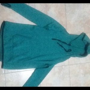 A teal jacket with very tiny black spots